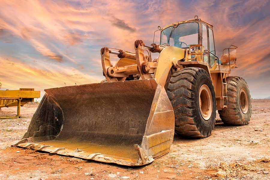 a large tractor parked in the dirt